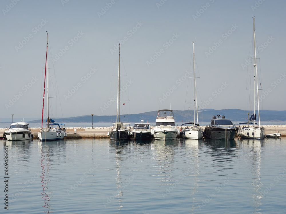 Sailboats moored at the marina of Baska Voda, Croatia. Yachts and boats in the Adriatic Sea.