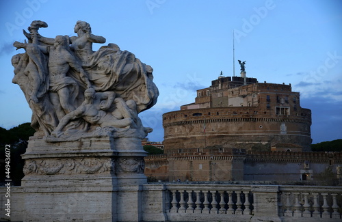 View of Castel Sant'Angelo and contrast with a symbolic sculptural group, under the blue sky, Rome, Italy photo