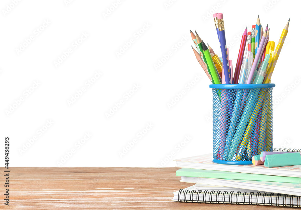 Obraz premium Holder with stationery on wooden table against white background