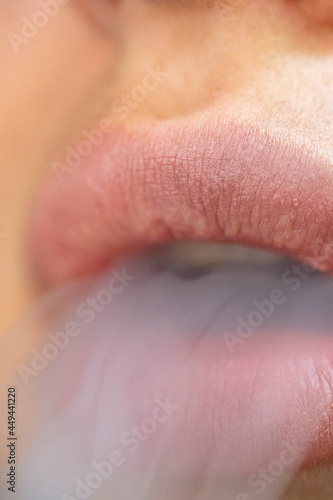 Smoke from cigarettes from hookah come out of the lips, macro. close-up. High quality photo