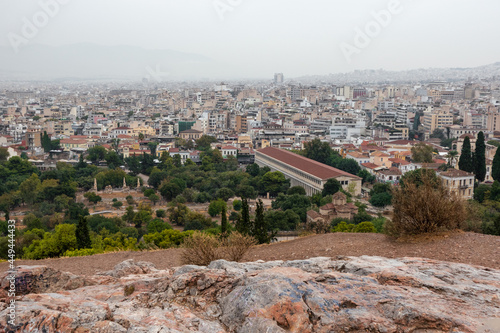 View on Stoa of Attalos, Odeon of Agrippa and Athens old city center with rocky hill in gray foggy day from Areopagus - Hill near Acropolis photo