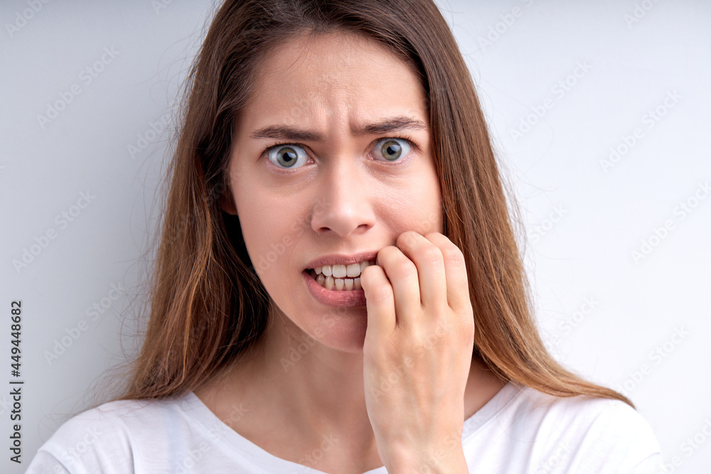 Portrait of worried surprised caucasian woman keeping hands on mouth, concerned, isolated over white studio background. People face expressions and reaction concept. Nervous female at a loss Portrait of worried surprised caucasian woman keeping hands on mouth, concerned, isolated over white studio background. People face expressions and reaction concept. Nervous female at a loss