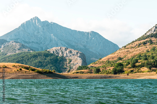 Landscape of the mountains of the Porma reservoir in Castilla y Leon.The photograph is taken from the water's edge, which is reached by a detour along a curvy road that is heavily visited by motorists photo