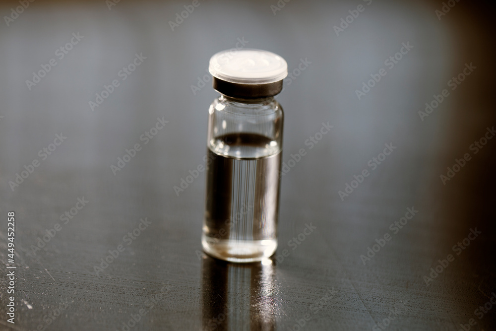 Glass vaccine bottle. Vaccination medicine global programm. 