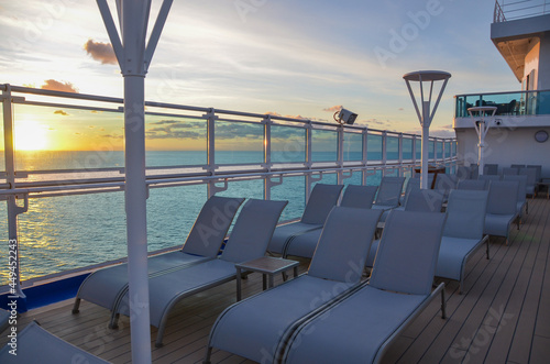 Cruise ship lounger chairs on sun deck at sunset © Silverpics