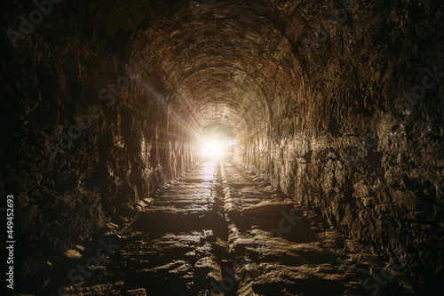 Dark and creepy old historical vaulted underground road tunnel photo