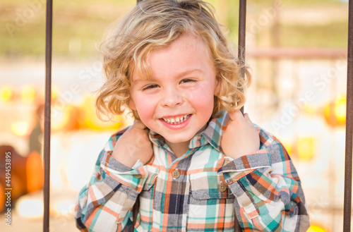 Little Boy Having Fun in a Rustic Ranch Setting at the Pumpkin Patch. © Andy Dean
