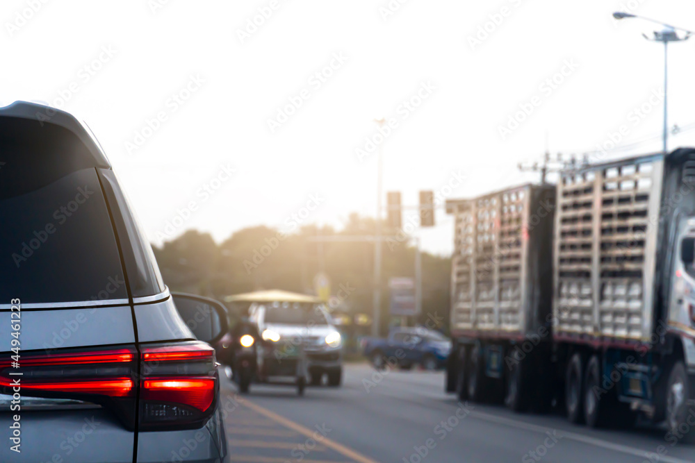 Abstract and blurred of rear side car with light of brake. Stop on the asphalt road with other cars in the evening.