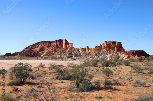 Amazing Rainbow Valley in Northern Territory, Australia, just outisde Alice Springs. Beautiful red and orange rock formation with blue sky and orange sands