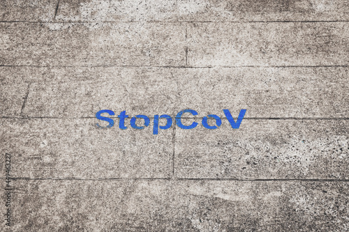 Stopcov sign painted on the road, blue text, selective color. Prevention of Coronavirus Spread in Georgia