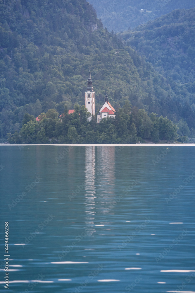 Fototapeta premium Panorama of the Blejsko ostrvo, or bled island, on Bled lake or Blejsko Jezero, with assumption of Maria church, or cerkev marijinega vnebovzetja. it's a catholic church in Slovenia