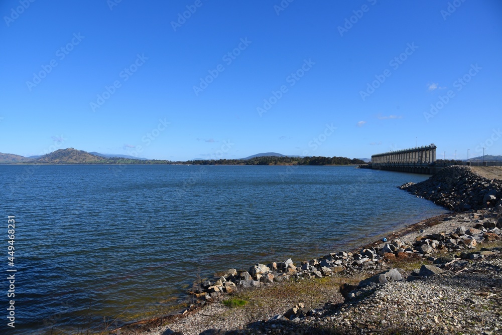 The Hume Dam, across the Murray River downstream of its junction with the Mitta River in the Riverina region with dark blue river of the Murray River. The Hume Dam, across the Murray River downstream of its junction with the Mitta River in the Riverina region with dark blue river of the Murray River.