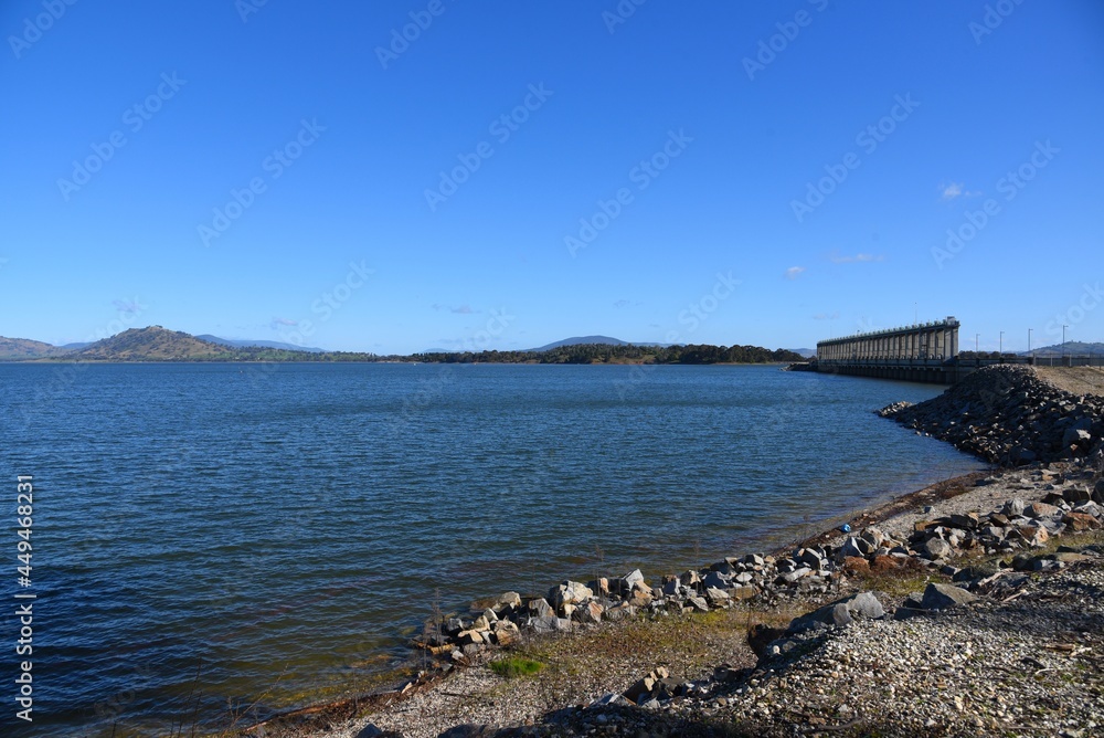 The Hume Dam, across the Murray River downstream of its junction with the Mitta River in the Riverina region with dark blue river of the Murray River.