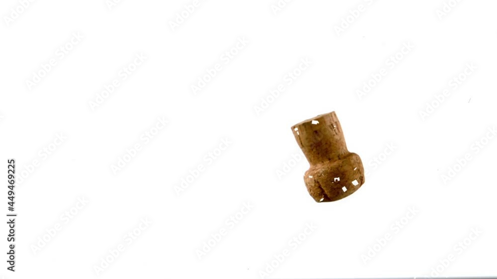 Confetti falling over wine cork falling against white background Confetti falling over wine cork falling against white background