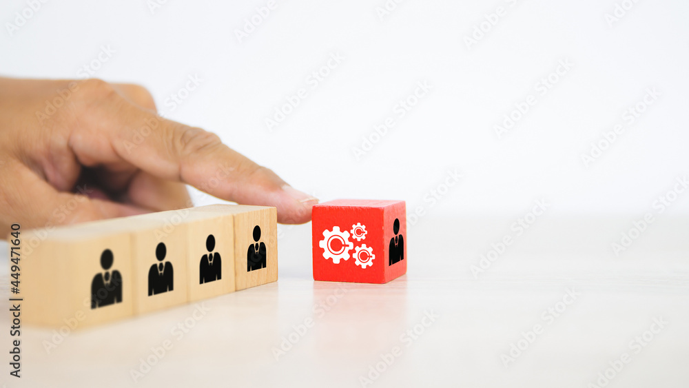 Hand choose human with cog icon on cube wooden block stack. Concepts of people business team creative thinking and resources for personnel leader and teamwork or leadership team player is performance. Hand choose human with cog icon on cube wooden block stack. Concepts of people business team creative thinking and resources for personnel leader and teamwork or leadership team player is performance.