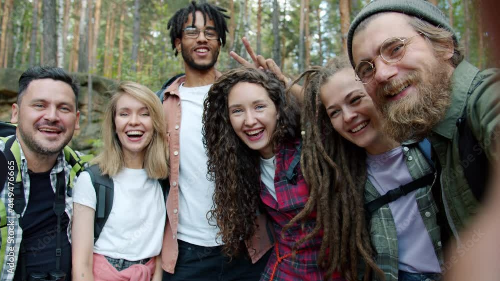 Slow motion POV portrait of happy youth friends taking selfie smiling looking at camera in forest in green summer. Photography and tourism concept. Slow motion POV portrait of happy youth friends taking selfie smiling looking at camera in forest in green summer. Photography and tourism concept.