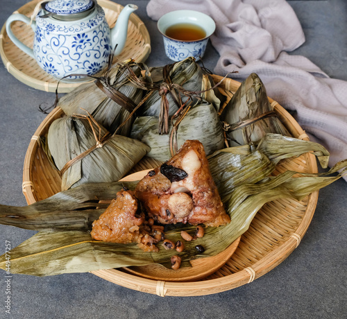 Eaten during the Duanwu festival. Zonzi aka Chinese Rice Dumplings. Wrapped in bamboo leaves with generous fillings of pork, mushrooms, salted egg yolk, chestnut, dried shrimps and glutinous rice. photo