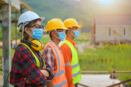 Workers wear a quarantine face mask