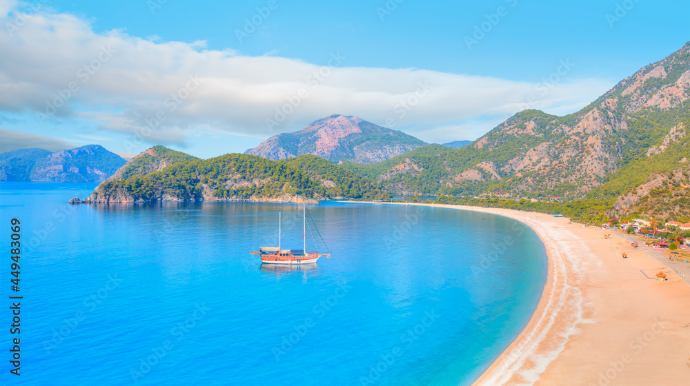 Brown gulet anchored  - Panoramic view of Oludeniz Beach And Blue Lagoon, Oludeniz beach is best beaches in Turkey - Fethiye, Turkey