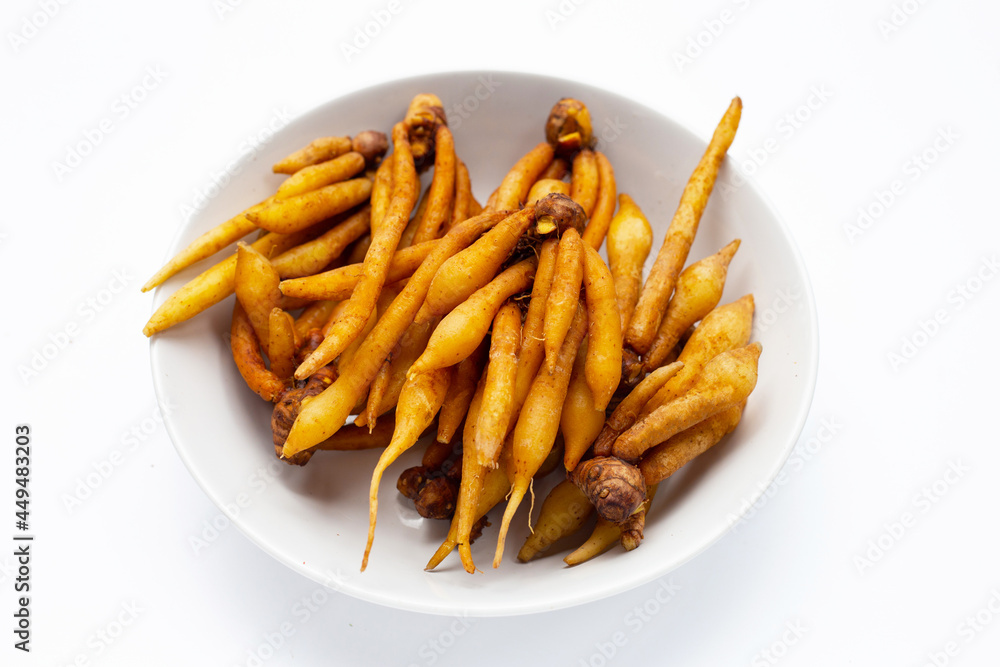 Finger root in white bowl on white background. Finger root in white bowl on white background.