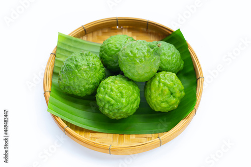 Bergamot kaffir lime herb fresh fruit in bamboo basket on white background.