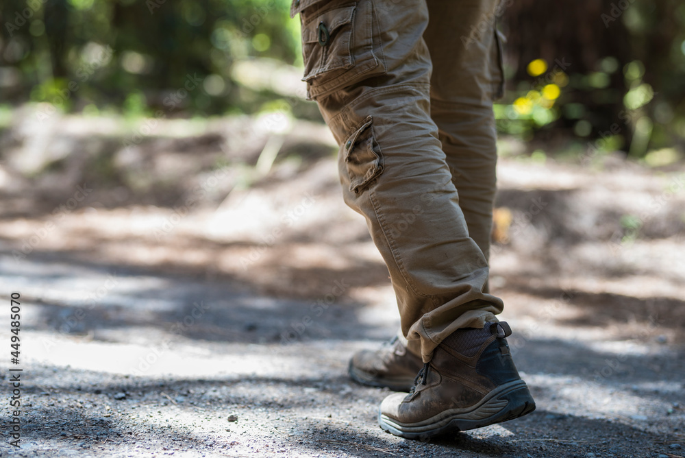 Close up of man shoes trekking boot walking on the path in mountain outdoor leisure activity - equipment and active free lifestyle people concept Close up of man shoes trekking boot walking on the path in mountain outdoor leisure activity - equipment and active free lifestyle people concept