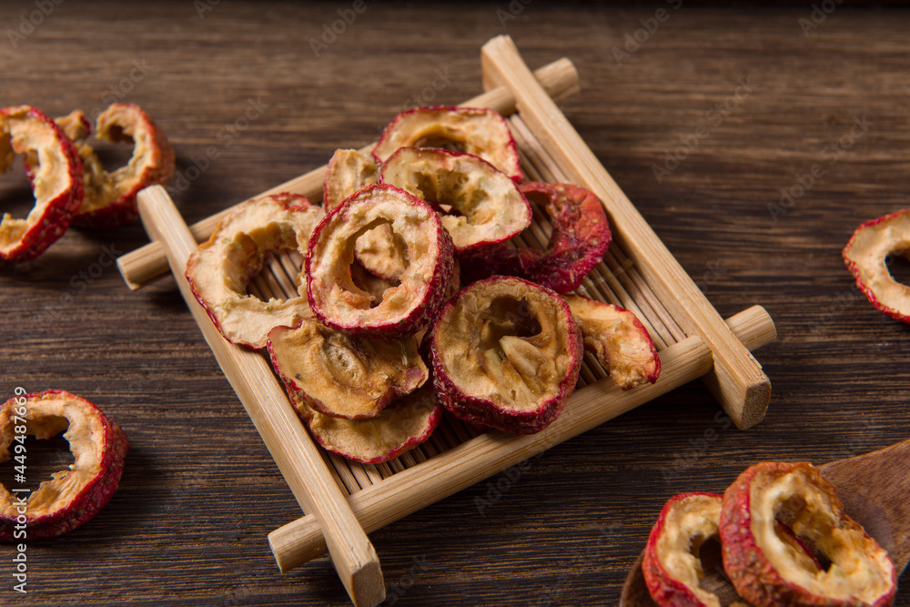 Dried hawthorn slices on wooden background Dried hawthorn slices on wooden background