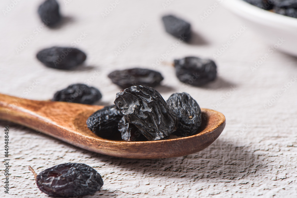 Dried fruits, pile of black raisins on table. Dried fruits, pile of black raisins on table.