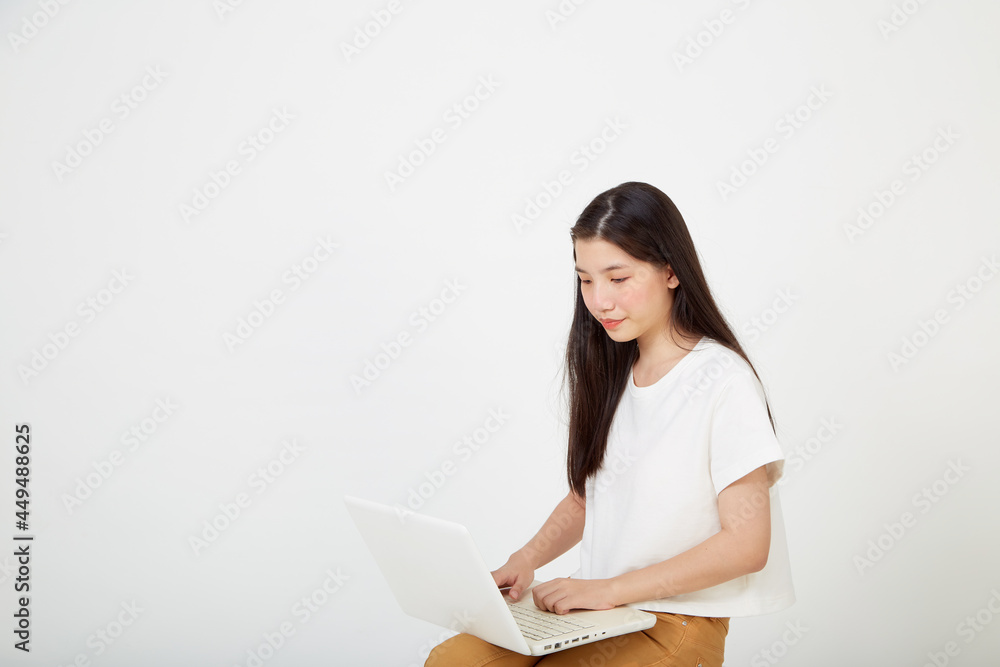 woman with laptop computer sitting cross legged and looking woman with laptop computer sitting cross legged and looking
