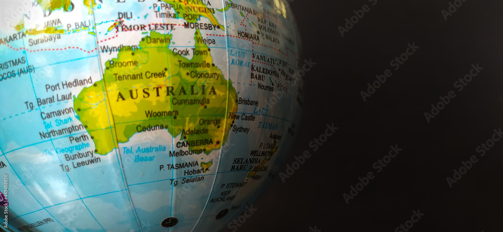 Australian globe on black background. The Australian continent is visible in the globe, complete with copy space for tex needs.