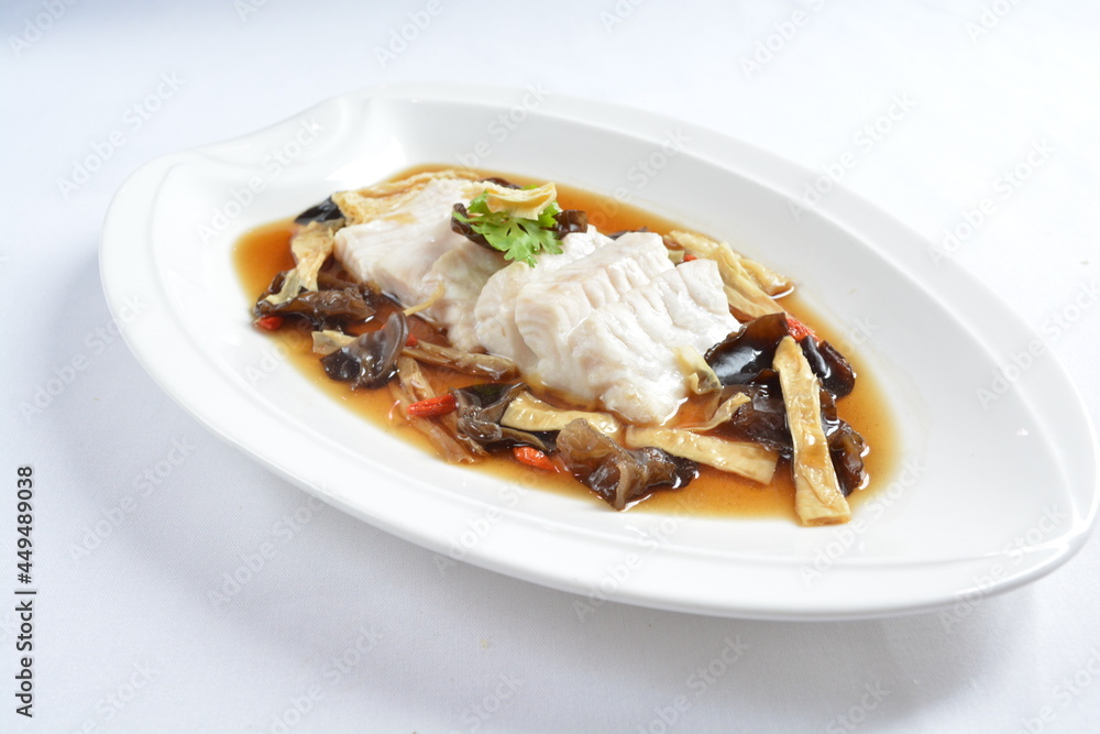 steamed slices grouper fish fillet with Chinese herbal fungus miso sauce seafood in white background asian halal seafood menu steamed slices grouper fish fillet with Chinese herbal fungus miso sauce seafood in white background asian halal seafood menu