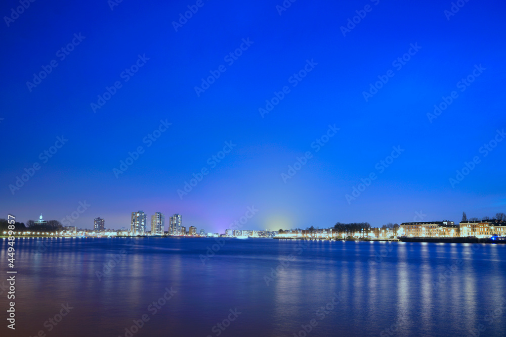 Distant view of a coastal city's cityscape at night