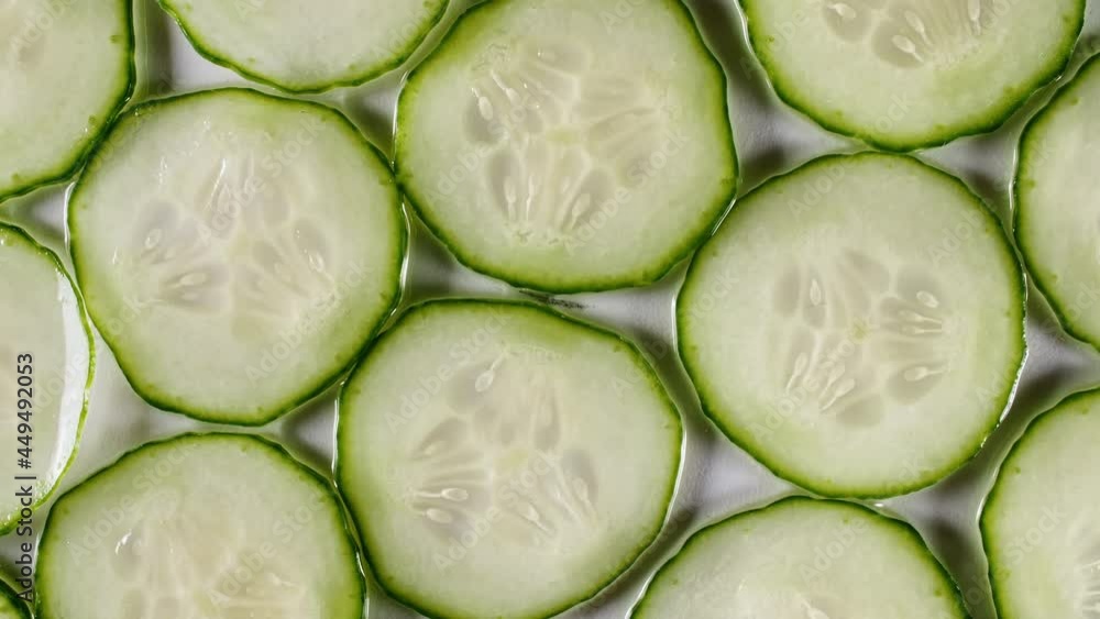 Macro Shot of Sliced Cucumber Fruit Slices and Rotate. Cucumber Pattern. Healthy Food Background. Slow Motion. High quality 4k footage Macro Shot of Sliced Cucumber Fruit Slices and Rotate. Cucumber Pattern. Healthy Food Background. Slow Motion. High quality 4k footage