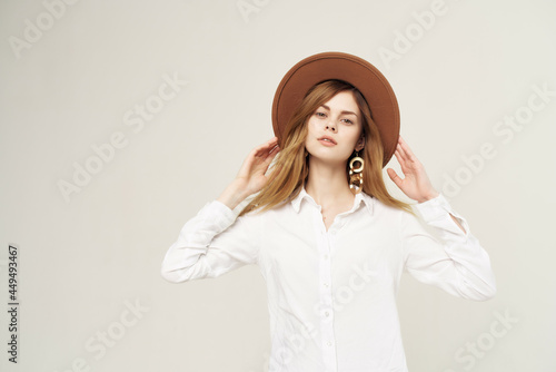 woman in white shirt wearing hat modern style posing glamor isolated background