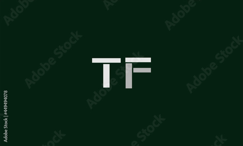 TF logo is unique and attractive logo with a very unique design.Grey and white colorb with dark green background photo