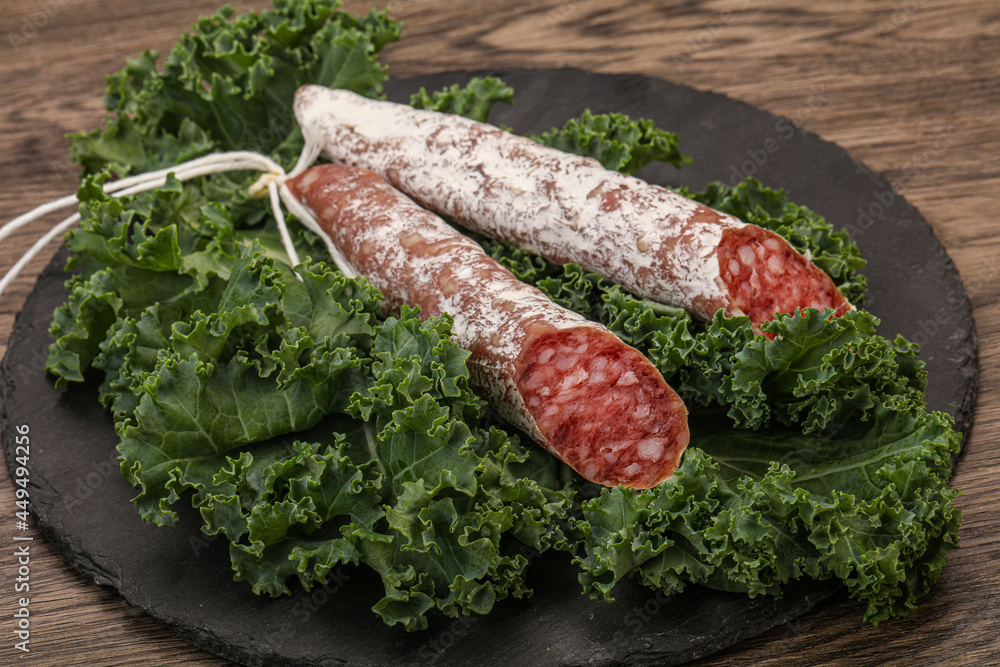 Spanish Fuet sausage with salad leaves Spanish Fuet sausage with salad leaves