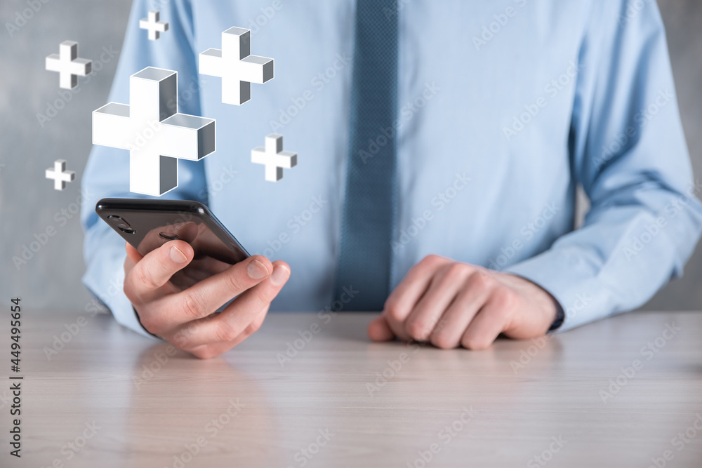 Businessman hold 3D plus icon, man hold in hand offer positive thing such as profit, benefits, development, CSR represented by plus sign.The hand shows the plus sign Businessman hold 3D plus icon, man hold in hand offer positive thing such as profit, benefits, development, CSR represented by plus sign.The hand shows the plus sign