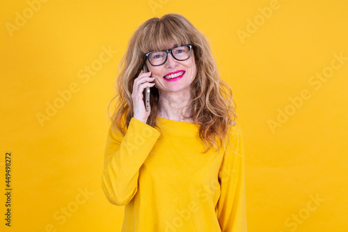 Cuadro en lienzo adult woman with mobile phone isolated