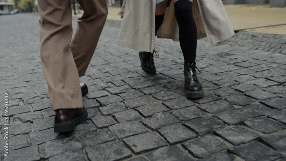 Couple legs bouncing on city street. Unknown man and woman walking outdoor. Couple legs bouncing on city street. Unknown man and woman walking outdoor.
