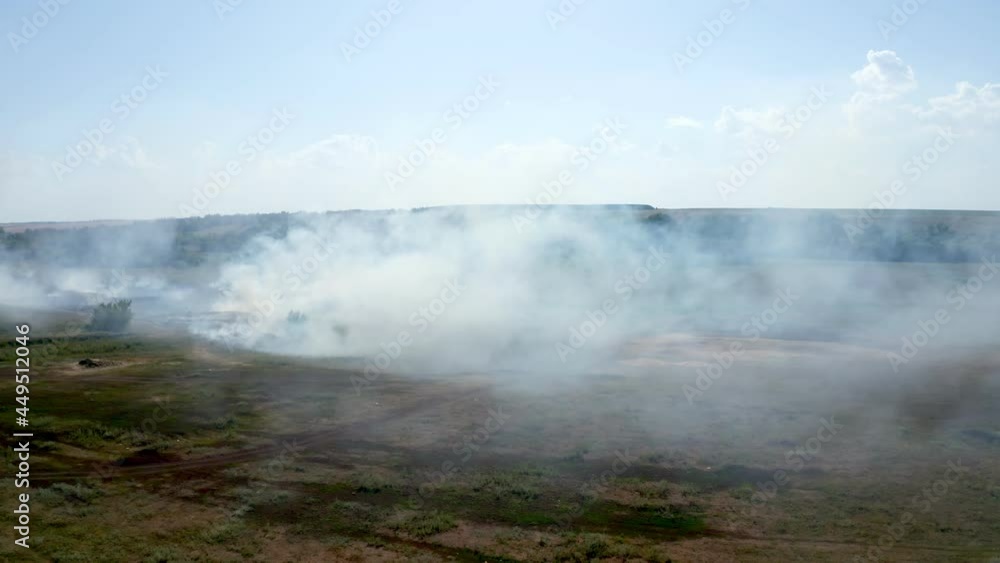 Burning of peat in natural areas. Gray smoke from peat fires rises high into the sky. Drained swamp, emergency. High quality. 4k footage.