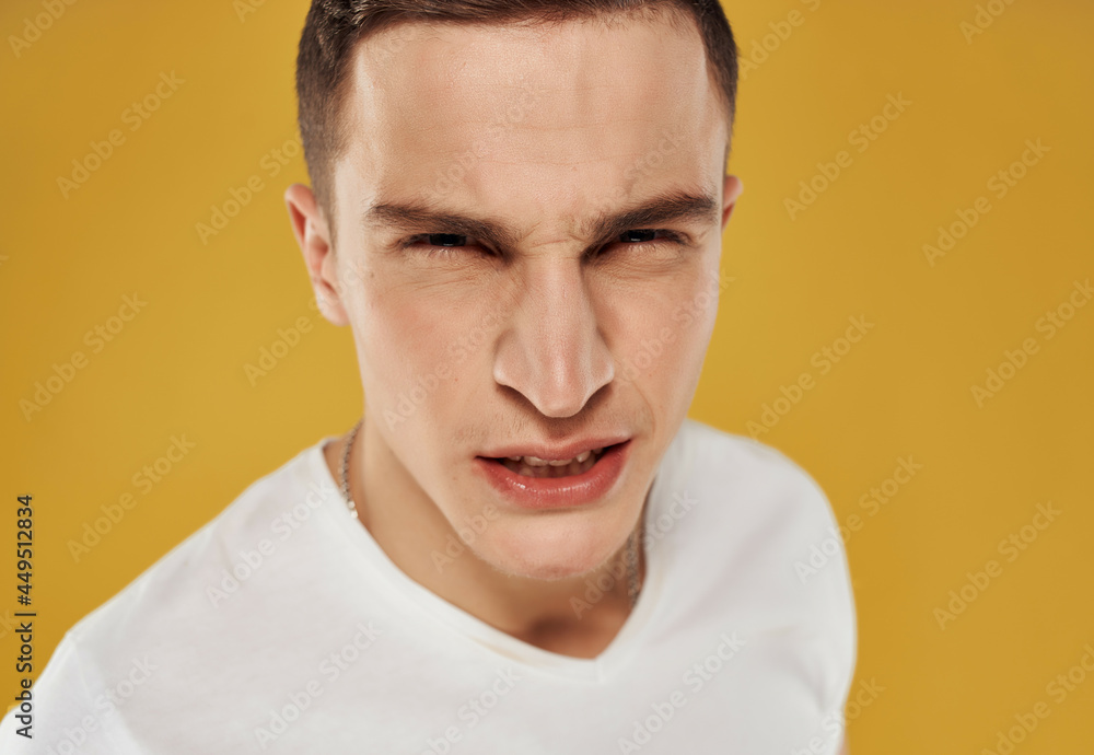 Obraz premium angry man in white t-shirt emotion close-up isolated background