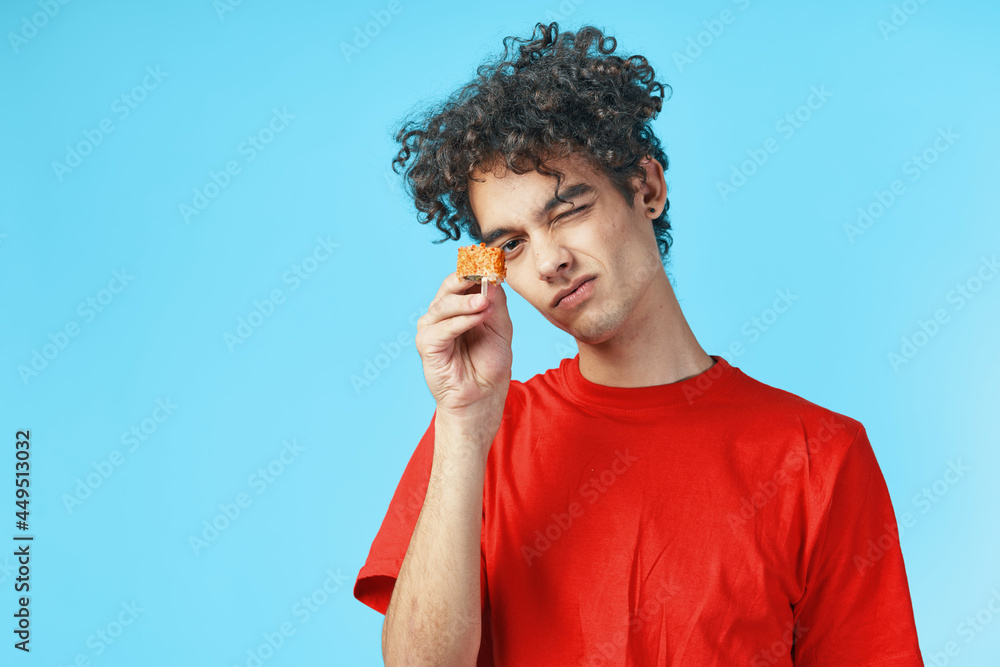 man in red t-shirt curly hair dry snack japanese fast food man in red t-shirt curly hair dry snack japanese fast food