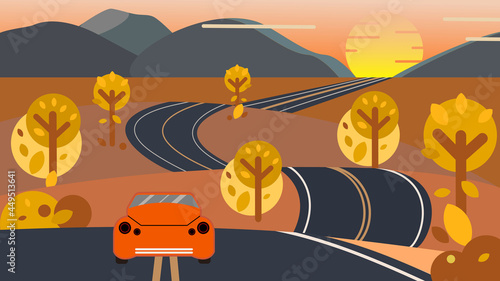 Bright orange car on a winding road that leads to horizon. Autumn road trip concept