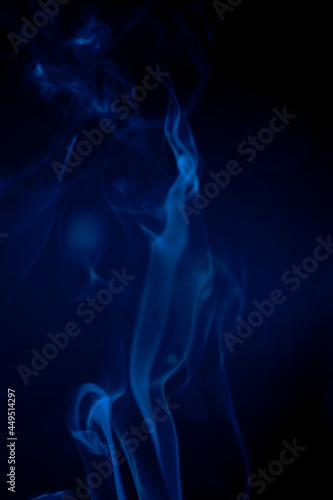 Blue smoke on black background.