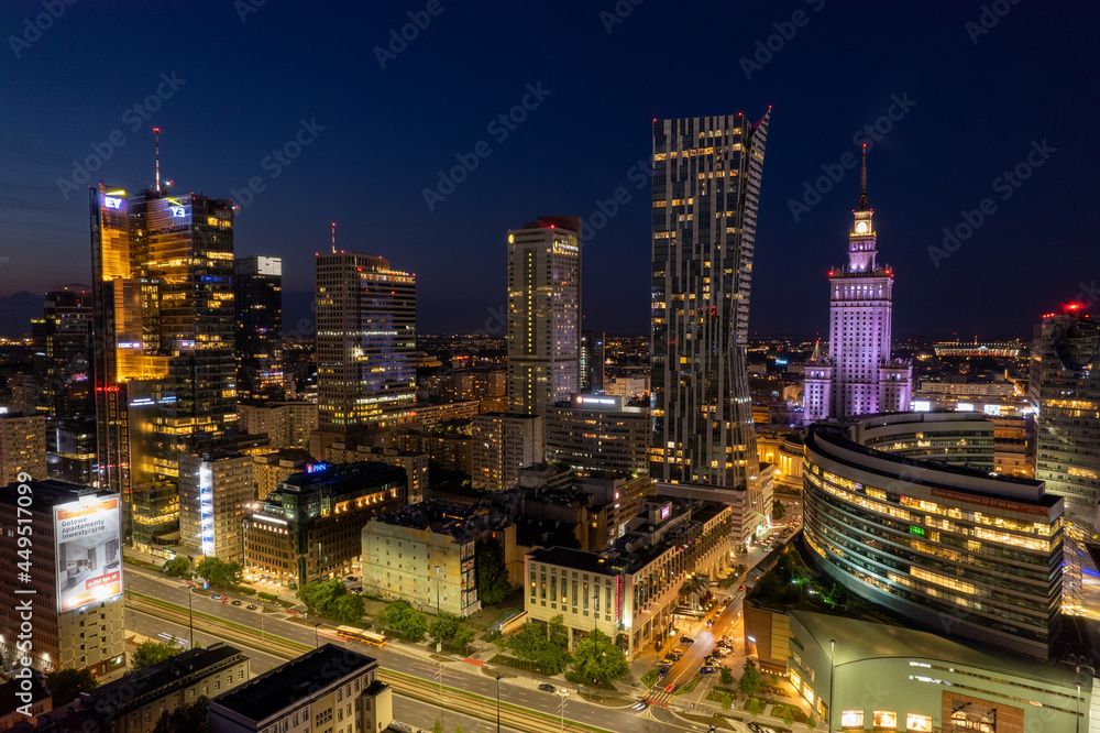 Warsaw by night. Amazing lights, skyscrapers and bridges over the Vistula River. View of the glowing lights in Warsaw from the drone. The capital of Poland miraculously shown at night.