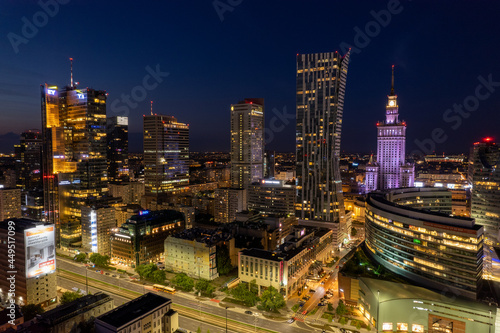 Warsaw by night. Amazing lights, skyscrapers and bridges over the Vistula River. View of the glowing lights in Warsaw from the drone. The capital of Poland miraculously shown at night.