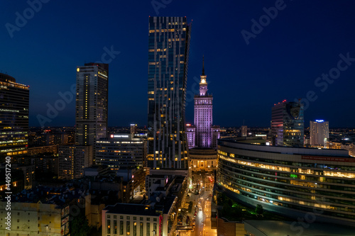 Warsaw by night. Amazing lights, skyscrapers and bridges over the Vistula River. View of the glowing lights in Warsaw from the drone. The capital of Poland miraculously shown at night.