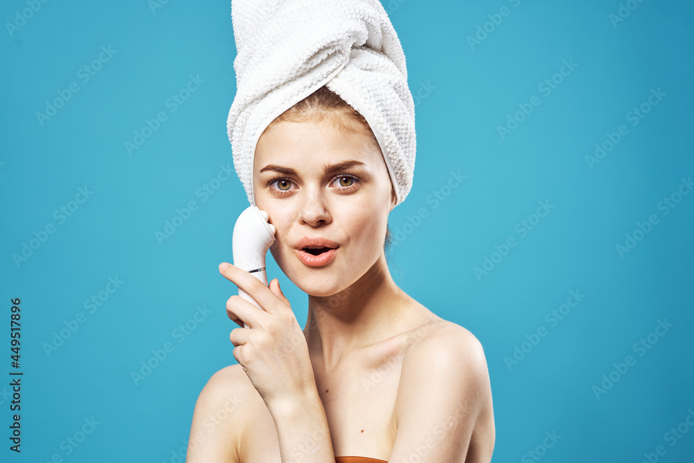 cheerful woman with bare shoulders with a massager in her hands cosmetology dermatology cheerful woman with bare shoulders with a massager in her hands cosmetology dermatology