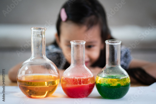 Unidentified 5 years old student is observe the water and oil separation for liquid density easy science experimental at home, homeschool, stem education, self learning for kid in family life. photo