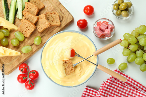 Concept of delicious food with fondue on white background